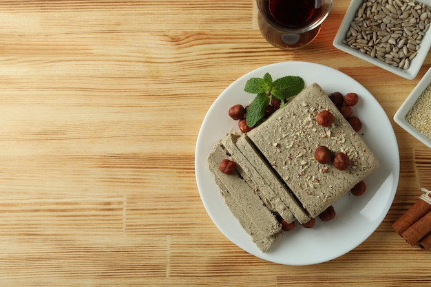 Concept of tasty food with halva on wooden background