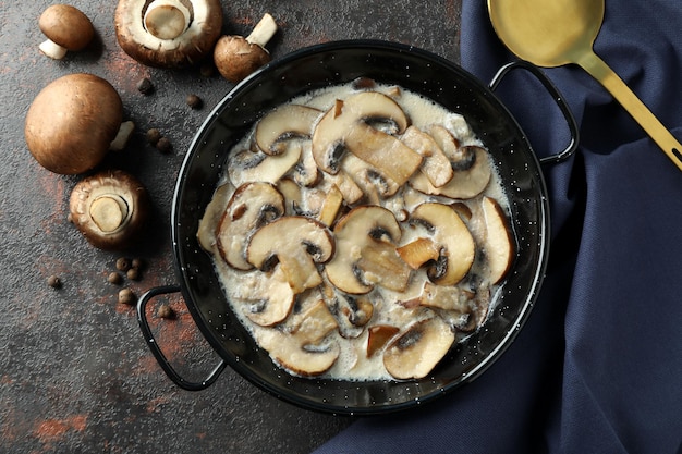 Concept of tasty food with mushroom sauce on dark textured background