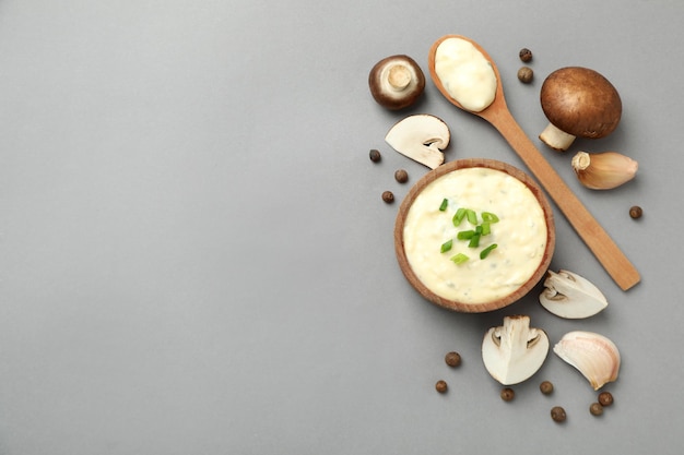 Concept of tasty food with mushroom sauce on gray background