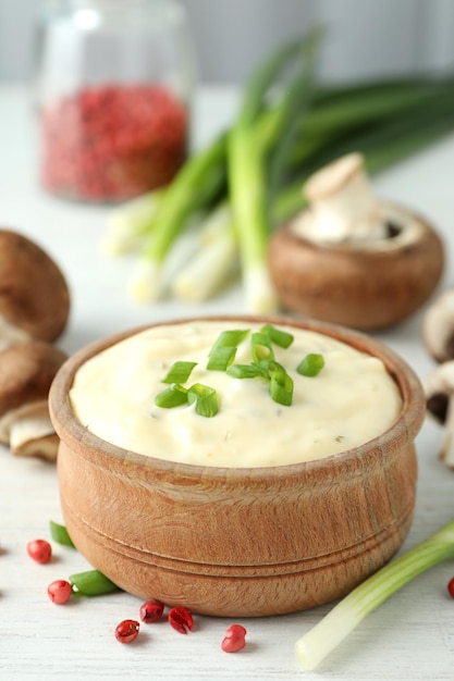 Concept of tasty food with mushroom sauce on white wooden background