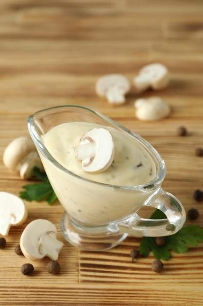 Concept of tasty food with mushroom sauce on wooden background