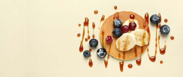 Photo concept of tasty food with pancake on beige background