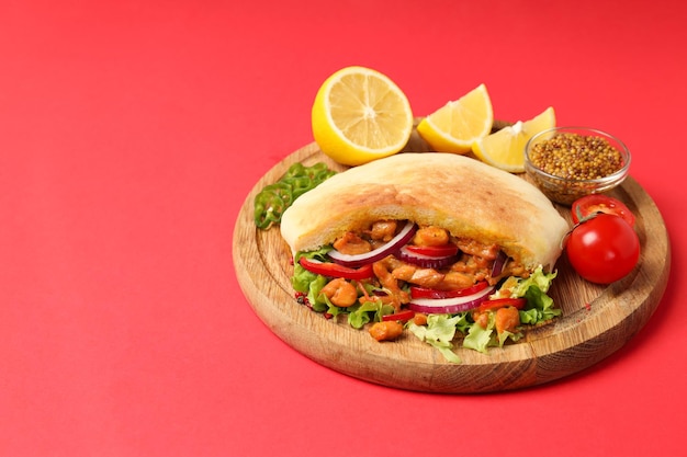 Concept of tasty food with pita with chicken space for text