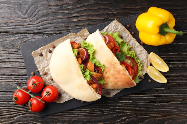 Concept of tasty food with pitas with chicken top view