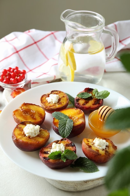 Concept of tasty food with plate with grilled peach