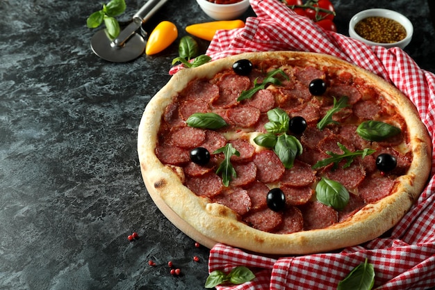 Concept of tasty food with Salami pizza on dark background