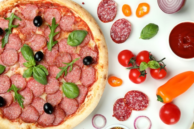 Concept of tasty food with Salami pizza on white background