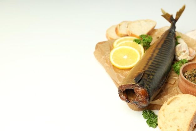 Concept of tasty food with smoked mackerel on white background