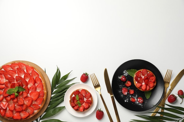 Concept of tasty food with strawberry tart on white background.