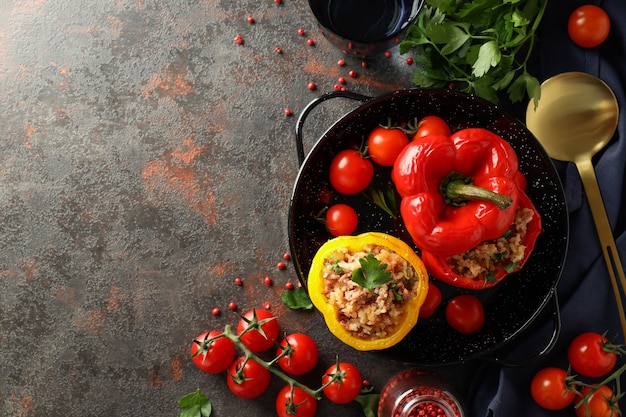 Concept of tasty food with stuffed pepper on dark textured background