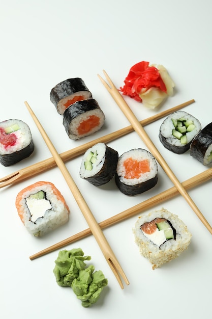 Concept of tasty food with sushi rolls on white background