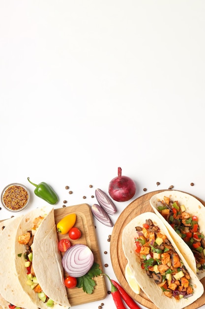 Concept of tasty food with taco on white background