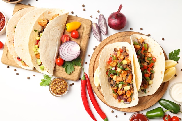 Concept of tasty food with taco on white background