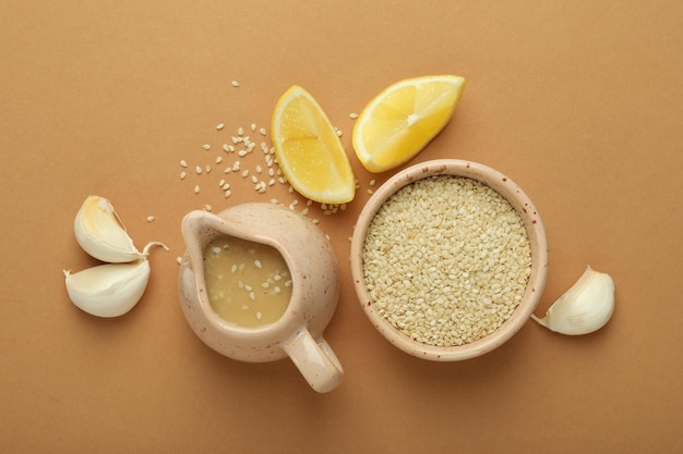 Concept of tasty food with tahini sauce on beige background