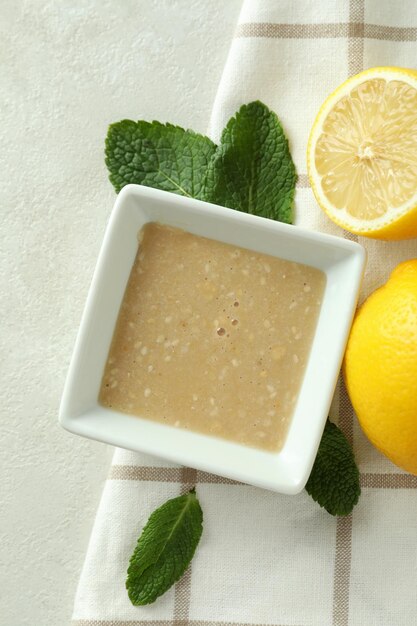 Concept of tasty food with tahini sauce on light texture background