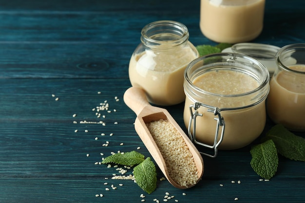 Concept of tasty food with tahini sauce on wooden background