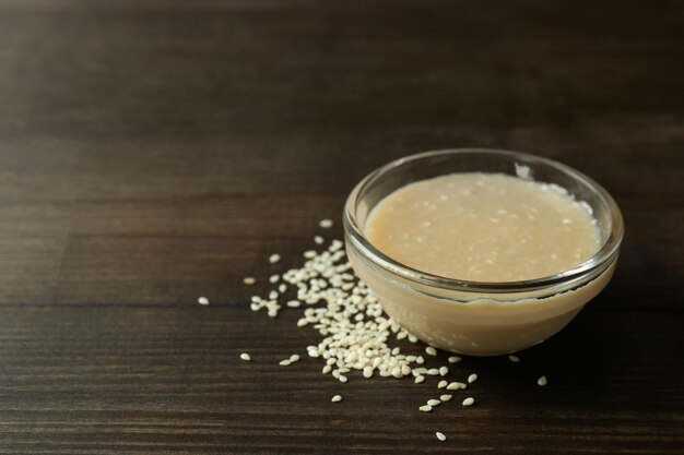 Concept of tasty food with tahini sauce on wooden background