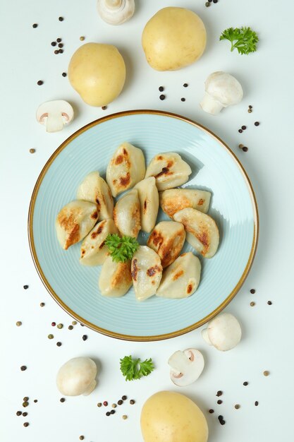 Concept of tasty food with vareniki or pierogi on white