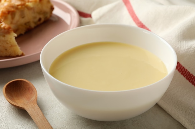 Concept of tasty lunch with bowl of condensed milk