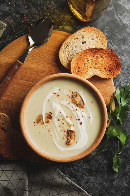 Photo concept of tasty lunch with bowl of mushroom soup