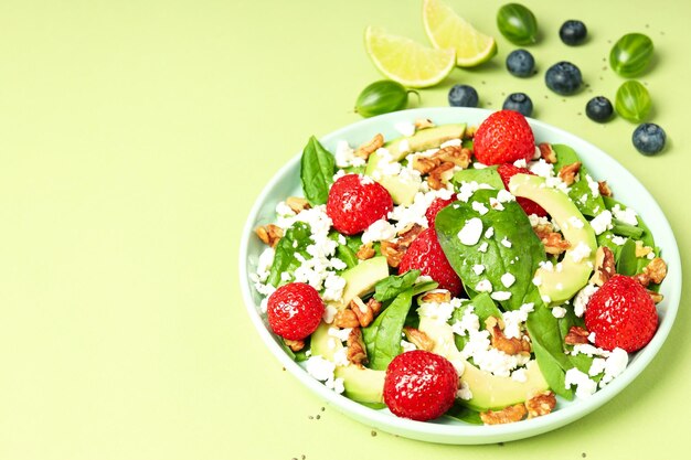 Concept of tasty salad salad with strawberry space for text