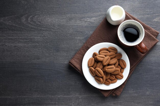 Concept of tasty snack for hot drink cookies in the shape of coffee seeds