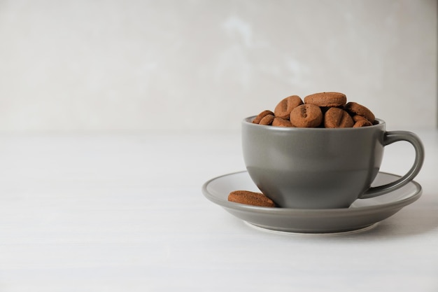 Concept of tasty snack for hot drink cookies in the shape of coffee seeds