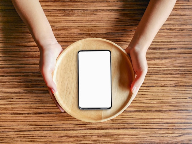 Concept topview smartphone on a wooden plate