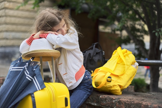 Photo concept of tourism, travel, little girl with luggage