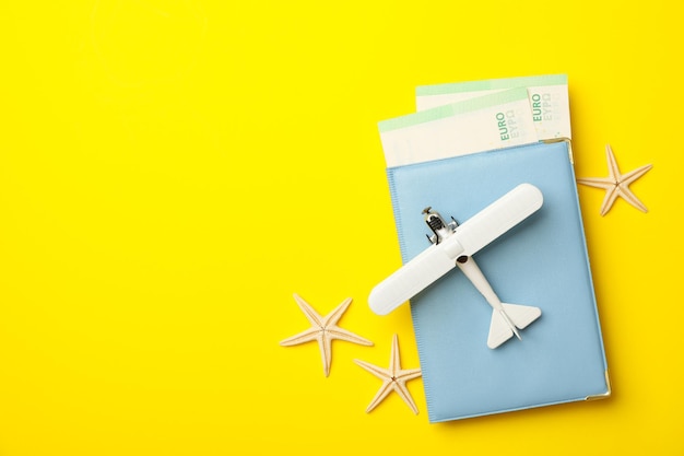 Concept of travel on yellow background, top view