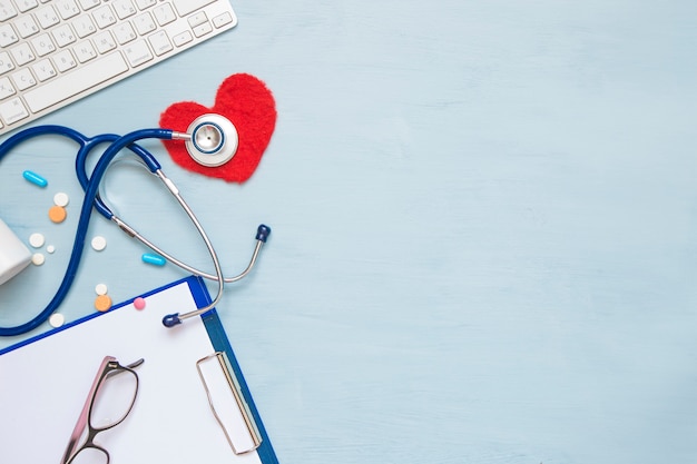 the concept of treating heart disease. stethoscope and medical attributes. 