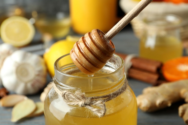 Concept of treatment colds with honey and garlic, close up