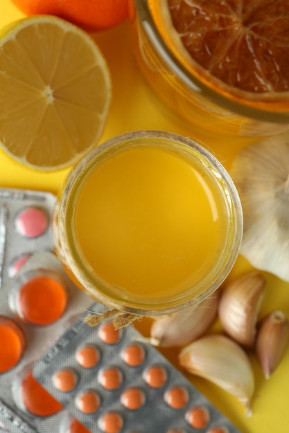 Photo concept of treatment colds with honey and garlic, close up