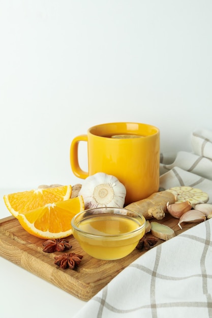 Concept of treatment colds with honey and garlic on white background