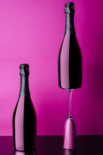 Concept of two bottles and glass of pink rose champagne