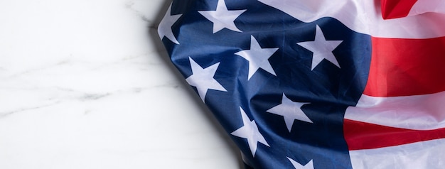 Concept of U.S Independence day or Memorial day. National flag over bright marble table background.