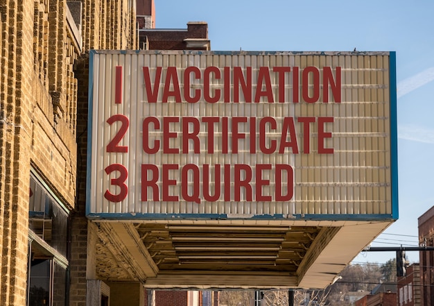 Concept of vaccination mandate for entry into public areas on\
cinema board