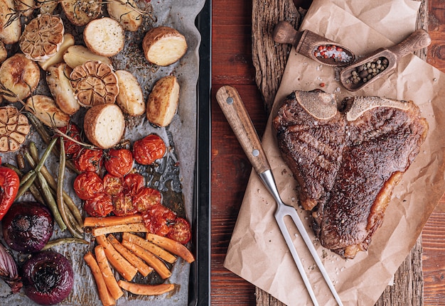 Concept van een heerlijk diner voor twee van een heerlijke sappige verse boer Gemarmerde biefstuk gegrild met gebakken groenten