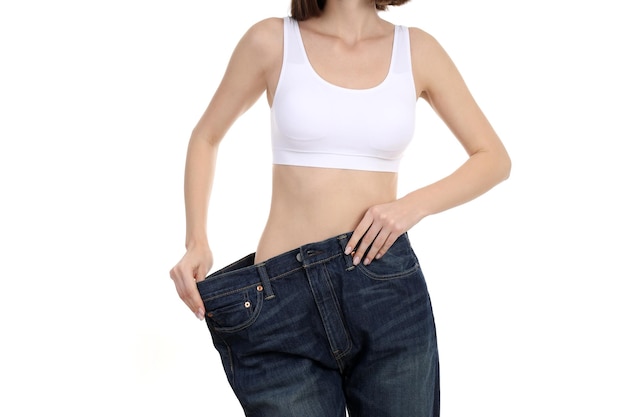 Concept van gewichtsverlies met jonge slanke vrouw geïsoleerd op een witte achtergrond