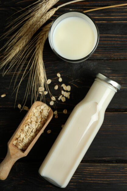 Concept of vegan milk on wooden background