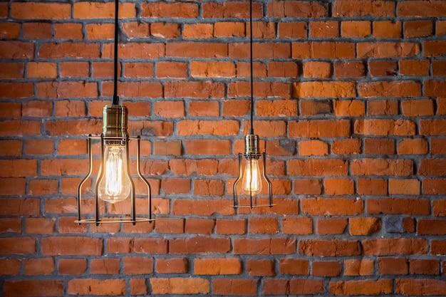 Concept vintage bulbs on brick wall, copy space for text