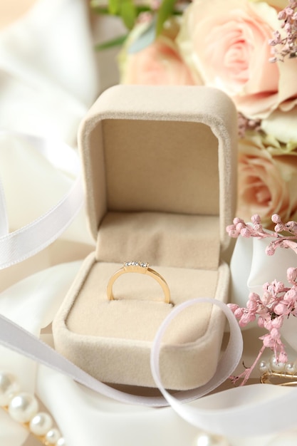 Concept of wedding accessories with wedding ring, close up