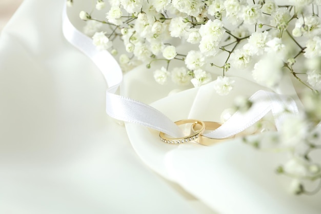 Concept of wedding accessories with wedding rings, close up