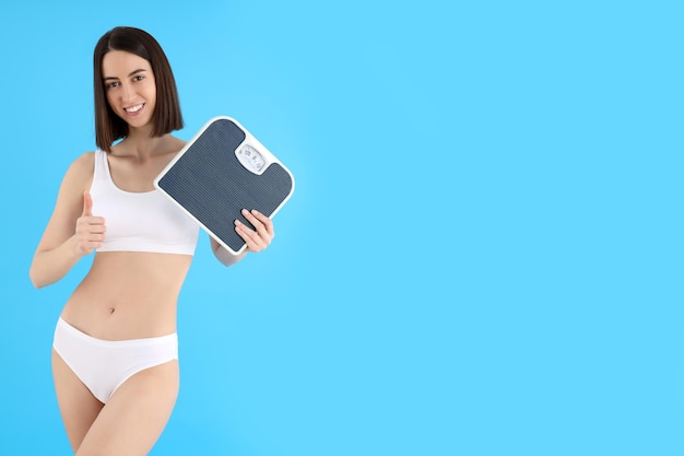 Concept of weight loss with thin girl on blue background