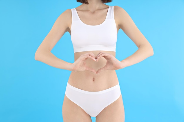 Concept of weight loss young woman on blue background