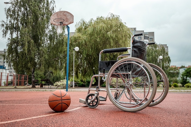 The concept of a wheelchair on the sports ground, a disabled person, a fulfilling life, paralyzed. Wheelchair on the basketball court.