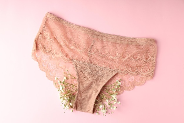 Concept of women's clothes with panties on pink background