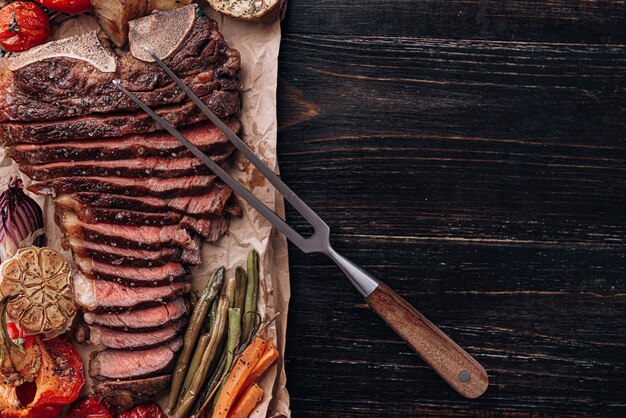 concept of a wonderful dinner for two of a delicious juicy fresh farmer marbled beef steak grilled with baked vegetables