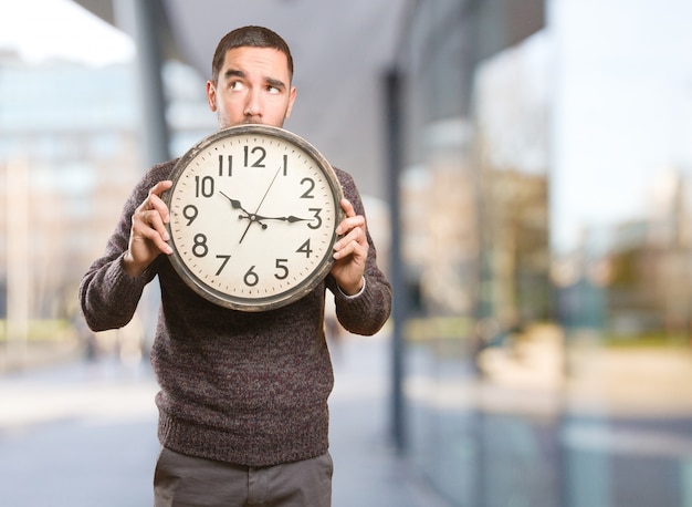 Photo concept of a young man worried about the time