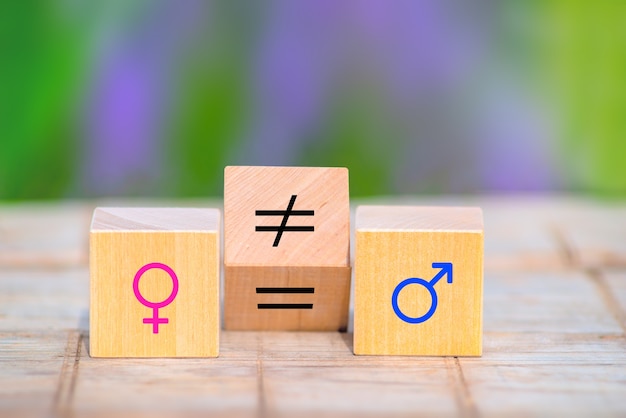 Concetti di uguaglianza di genere. cubo di legno con simbolo disuguale cambia in segno di uguale